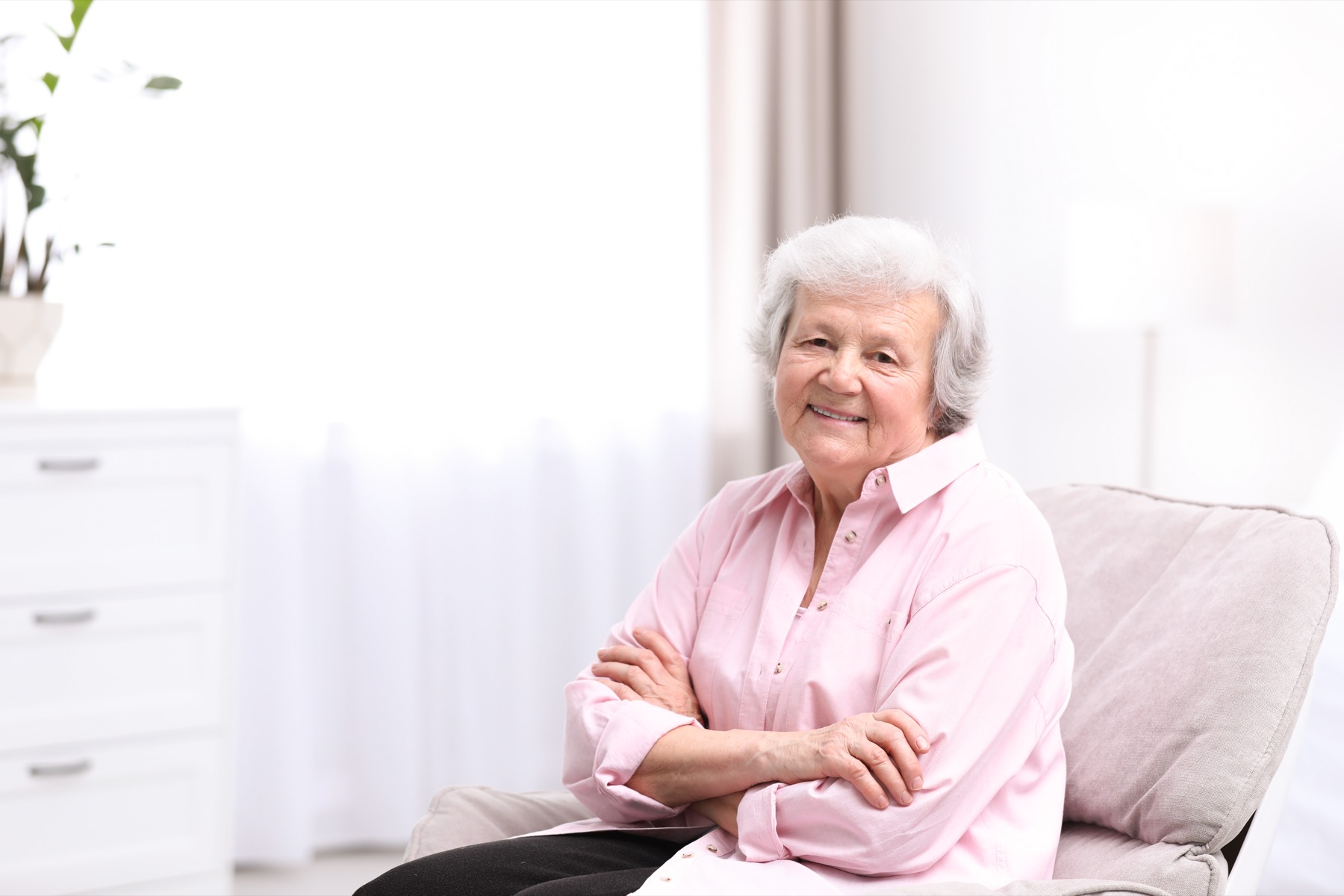 Senior woman smiling at home